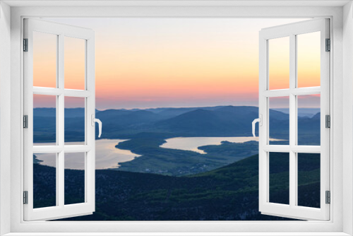 Fototapeta Naklejka Na Ścianę Okno 3D - the view of two lakes from the height of the mountain, in the light of the setting sun, the clear cloudless sun. Spring view of the Crimea.