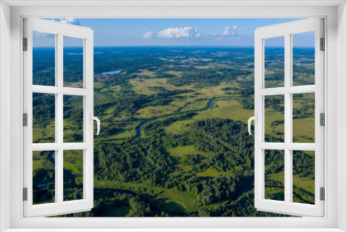 Fototapeta Naklejka Na Ścianę Okno 3D - Aerial view of a winding river in a green country