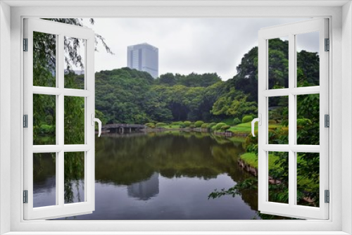 Fototapeta Naklejka Na Ścianę Okno 3D - Traditional Japanese gardens in public parks in Tokyo, Japan. Views of stone lanterns, lakes, ponds, bonsai and wildlife walking around paths and trails. Asia. 