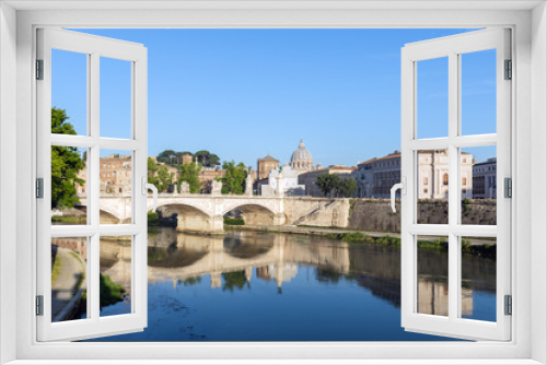 Fototapeta Naklejka Na Ścianę Okno 3D - St. Peter's Basilica and Emanuele II bridge with reflection in Tiber river at early morning.