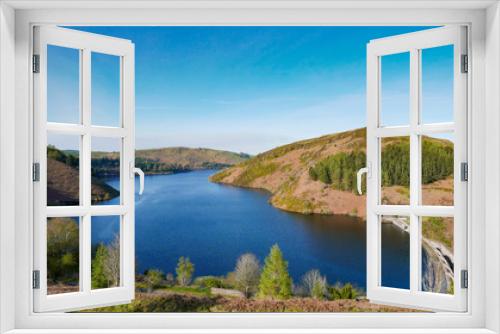 Fototapeta Naklejka Na Ścianę Okno 3D - Llyn Clywedog reservoir in Wales with blue skies and trees.