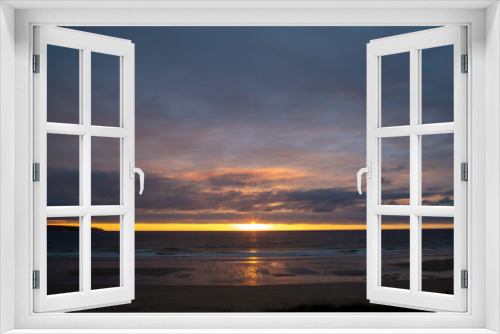 Fototapeta Naklejka Na Ścianę Okno 3D - Sunset over the beach in Cornwall with reflections in the sand