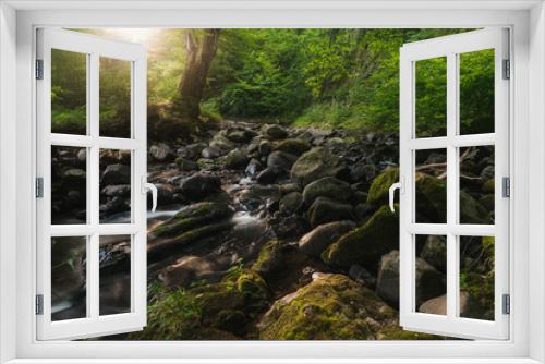Fototapeta Naklejka Na Ścianę Okno 3D - Small river and mossy rocks in a green forest. Peaceful landscape scene.