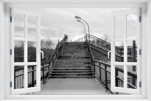 Fototapeta Naklejka Na Ścianę Okno 3D - Pedestrian bridge over the railway. Stairs. Black and white