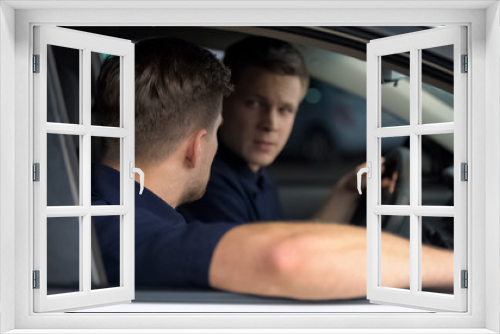 Two suspicious male friends planning crime sitting in car, dangerous business