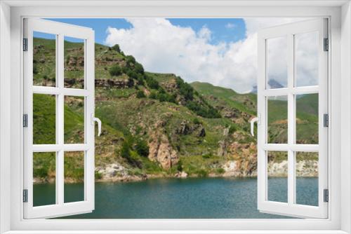 Fototapeta Naklejka Na Ścianę Okno 3D - white clouds cover the tops of the rocky mountains. near the pond with clear mountain clear water and mountains with Alpine meadows