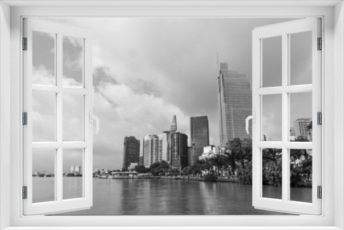 Fototapeta Naklejka Na Ścianę Okno 3D - black and white skyline view from the river. modern building, high rise Relection on water of  Asiatic Metropolis of  Saigon know also as Ho Chi Minh city, Vietnam.