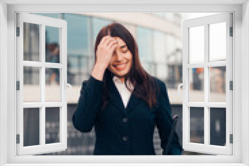 Successful smile businesswoman or entrepreneur standing in front of his office.