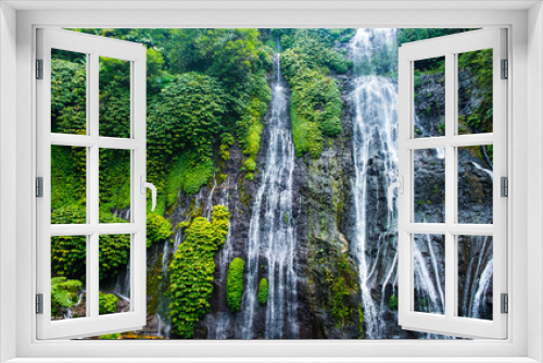Fototapeta Naklejka Na Ścianę Okno 3D - Banyumala  twin waterfall in mountain slope in Bali. Jungle waterfall cascade in tropical rainforest with rock and turquoise blue pond.  