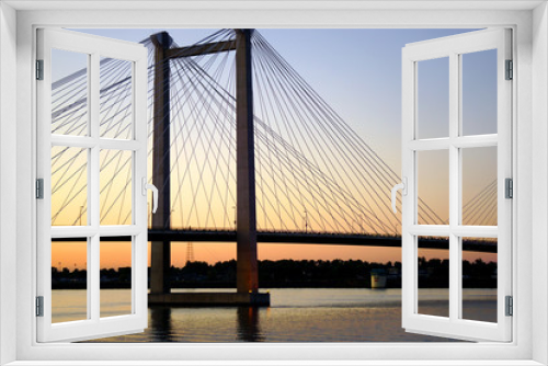 Fototapeta Naklejka Na Ścianę Okno 3D - Cable suspension bridge over river at dusk