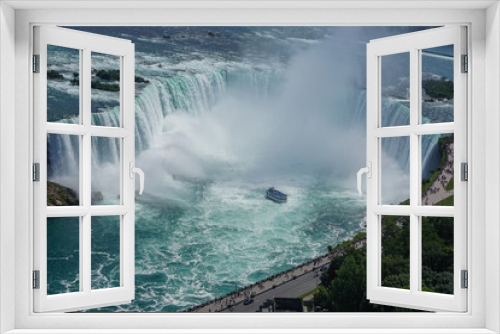 Fototapeta Naklejka Na Ścianę Okno 3D - Niagara Falls, Ontario, Canada: Aerial view of tourists watching as a tour boat approaches the Horseshoe Falls.