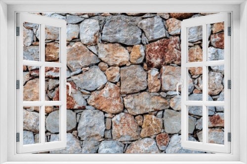 Fototapeta Naklejka Na Ścianę Okno 3D - Modern wall of large unprocessed pieces of rock, stones. Background stone wall.