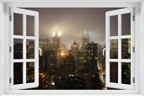 Fototapeta Naklejka Na Ścianę Okno 3D - New York City landscape at night with lights building translucid by the fog