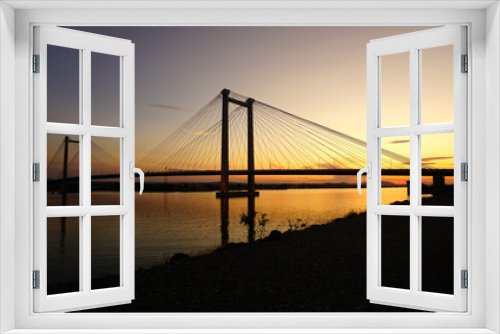 Fototapeta Naklejka Na Ścianę Okno 3D - suspension bridge over river at sunset