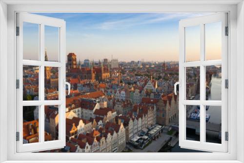 Fototapeta Naklejka Na Ścianę Okno 3D - Gdansk is a city in Poland. Gdansk in the morning rays, the sun is reflected from the roofs of the old city.