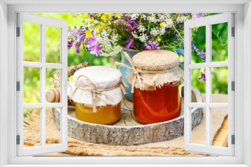 Fototapeta Naklejka Na Ścianę Okno 3D - Jars with honey and bouquet of wild flowers in the garden.