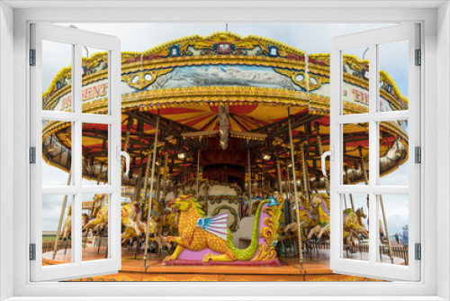 Fototapeta Naklejka Na Ścianę Okno 3D - Brightly coloured carousel on beach promenade.