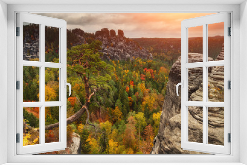Fototapeta Naklejka Na Ścianę Okno 3D - Colorful autumn landscape in the Saxony Bastei Mountains national park. View of exposed sandstone rocks and forest hilly. Dresden. Concept of outdoor recreation in natural settings out of town. 