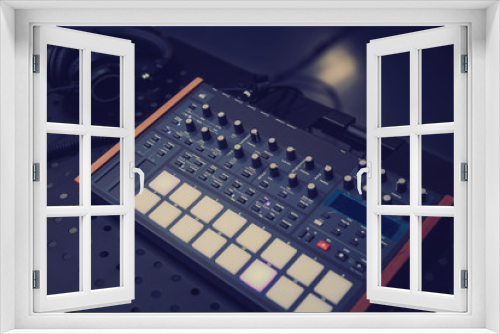 Analog synthesizer device and hi-fi headphones in sound recording studio.Professional musical instrument for edm producer.Compose and play new music with high quality audio equipment