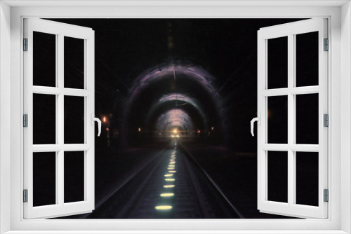 Fototapeta Naklejka Na Ścianę Okno 3D - Bright train lights coming towards camera in a dark railway tunnel