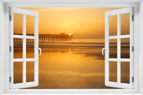Fototapeta Naklejka Na Ścianę Okno 3D - Golden sunrise over Atlantic ocean beach. Scenic marine landscape with wooden pier and calm ocean in soft sun light during sunrise at Pawleys Island, South Carolina, USA. 