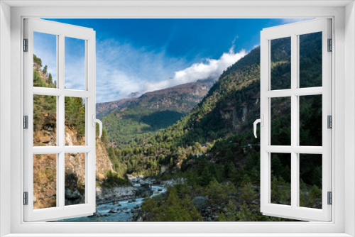 Fototapeta Naklejka Na Ścianę Okno 3D - We started hiking through the wondrous pine tree forests and around the Dudh Kosi river. This river originates from the high-altitude areas of Mount Everest and provides the area with essential water
