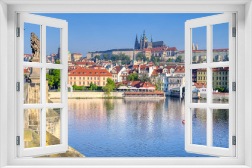 A view across the Charles Bridge and the Vltava River to Prague Castle and St. Vitas Cathedral in Prague, Czech Republic.