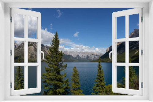 Fototapeta Naklejka Na Ścianę Okno 3D - Beautiful Panoramic View of Canadian Mountain Landscape during a vibrant sunny summerday. Taken in Lake Minnewanka, Banff National Park, Alberta, Canada.