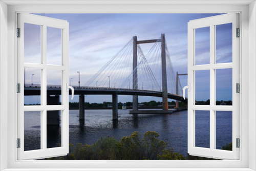 Fototapeta Naklejka Na Ścianę Okno 3D - Cable-stayed bridge over river at sunset