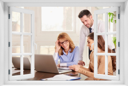 Teamwork in the office. Group of business people working together on laptop in the office