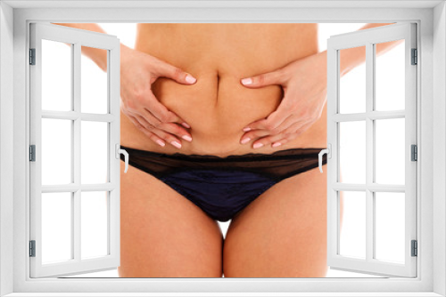 Closeup shot of overweight woman pinching her excessive belly fat, isolated on white background