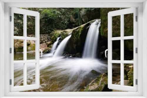 Fototapeta Naklejka Na Ścianę Okno 3D - idyllic small waterfall in lush green forest landscape