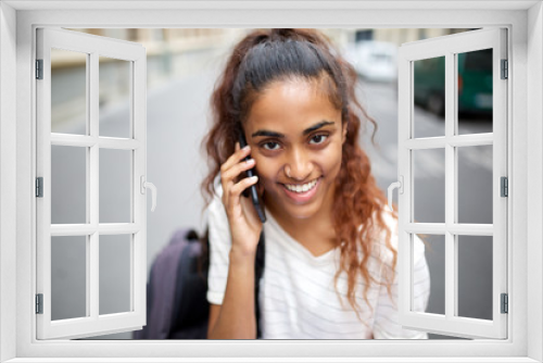 Close up beautiful young woman smiling and talking with phone on street