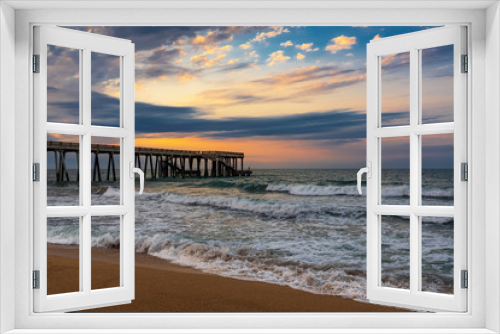 Fototapeta Naklejka Na Ścianę Okno 3D - Pier at sunset, wavy beautiful sea