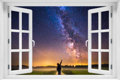 Fototapeta Naklejka Na Ścianę Okno 3D - Landscape with Milky way galaxy and man silhuette pointing to the stars