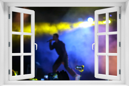 Fototapeta Naklejka Na Ścianę Okno 3D - Blurred background to place text. Blurred Music Festival Background of a large hip hop concert in a nightclub. Bright stage lighting, a crowded dance floor with music lovers enjoy the show.
