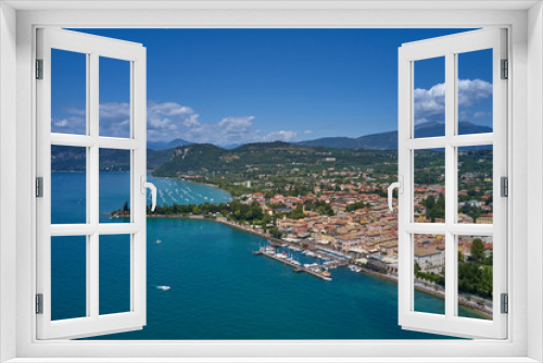 Fototapeta Naklejka Na Ścianę Okno 3D - Aerial photography. Beautiful coastline. In the city of Bardolino, Lake Garda is the north of Italy. View by Drone. Docked yachts parking in Port.