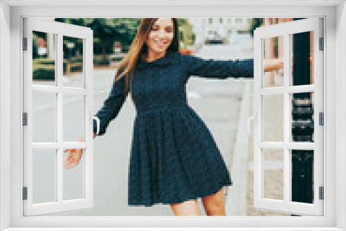 Outdoor portrait of happy beautiful woman, wearing mini dress