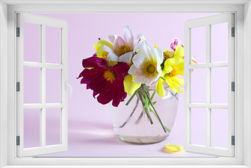 Fototapeta Naklejka Na Ścianę Okno 3D - Flowers in a glass jar on a pink background.