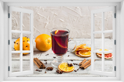 Fototapeta Naklejka Na Ścianę Okno 3D - Glass of delicious mulled wine with oranges anise cinnamon on white wooden table