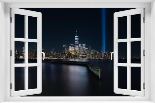 Fototapeta Naklejka Na Ścianę Okno 3D - Jersey City, NJ - USA - Aug 30 2019: The 9/11 Tribute in Lights temporary monument in lower Manhattan New York City view from New Jersey