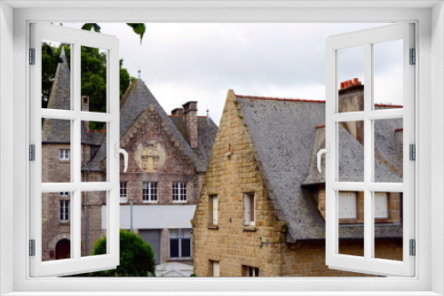 Fototapeta Naklejka Na Ścianę Okno 3D - Old historical stone building in a Breton town Dinan, Brittany, France. The medieval town on the hilltop has many fine old buildings. The town retains a large section of the city walls.