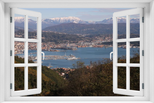 Fototapeta Naklejka Na Ścianę Okno 3D - Panoramic view of La Spezia in Liguria shot from above. A cruise ship in the port, numerous moored sailboats and commercial port cranes..