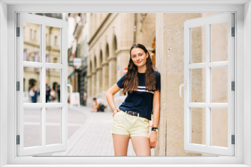 Outdoor portrait of pretty teenage girl on the city street