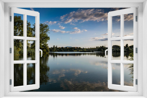 Fototapeta Naklejka Na Ścianę Okno 3D - Landscape of lake, mountains, vegetation, village and blue sky with white clouds.Lake Machilly, Haute-Savoie in France.