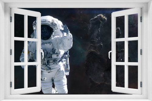 Fototapeta Naklejka Na Ścianę Okno 3D - Astronaut on background of the Pillars of Creation. Science fiction. Elements of this image furnished by NASA