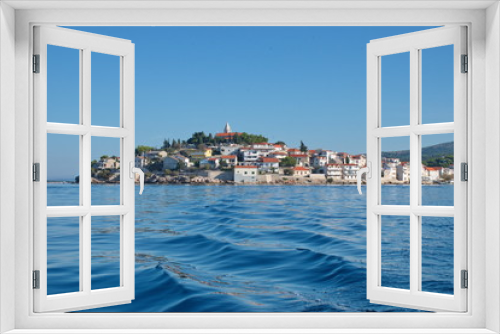 Fototapeta Naklejka Na Ścianę Okno 3D - Sailing on motor boat on Adriatic sea with Primosten cityscape in the background. Vacation in Croatia