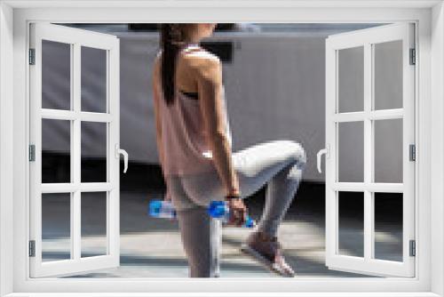 People Exercising with Plastic Water Bottle in Class at Gym with Music and Teacher on Stage