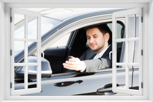 Young happy man bought new modern car.