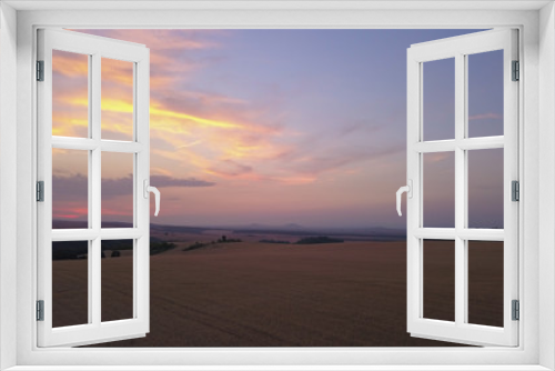 Fototapeta Naklejka Na Ścianę Okno 3D - Aerial view of a Agricultural fields at sunset or sunrise in Europe. Drone shot